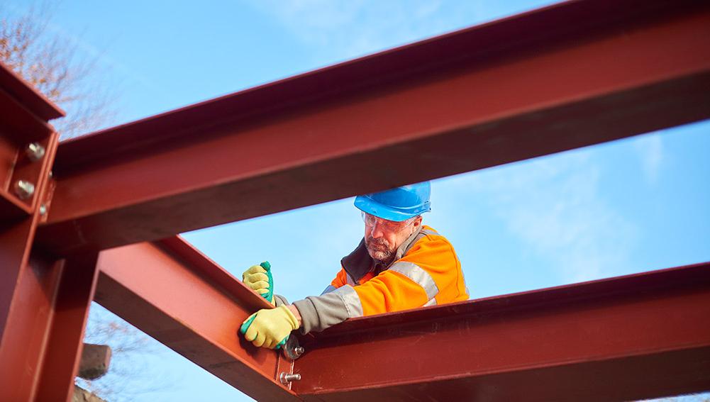 Construction worker assembling steel beams